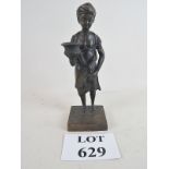 A cast bronze of an Indian boy wearing a turban and holding a vase, on plinth base,