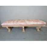 A decorative carved window seat with a t