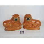 A pair of Victorian Staffordshire lion s