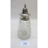 A heavy cut glass sugar caster with silv