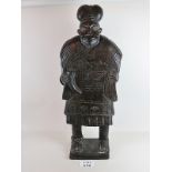 A large carved tribal statue of a man in
