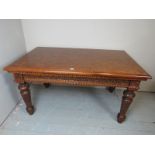 A C1900 carved oak dining table with orn