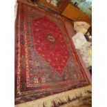 A fine Persian Qashqai carpet with central stylised animals on red field, 282 x 196 cm approx,