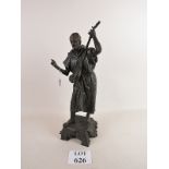A cast bronze statue depicting a musicia
