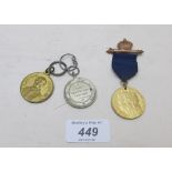 A collection of three various medallions