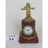 French style marble clock with ormolu mounts and surmounted by a cherub,