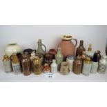 A large collection of stoneware to include advertising bottles, jugs and vases,