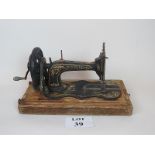 Victorian Singer sewing machine on fitted wooden base, hand cranked, portable,