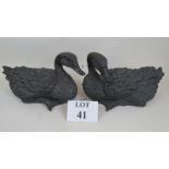 A pair of contemporary bronzed resin models of ducks,