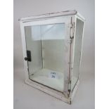 A mid-century/vintage medical/industrial painted metal standing cabinet, glass panels to 3 sides,