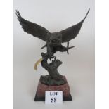 A stylish contemporary signed bronze sculpture 'Owl in Flight', on marble plinth vase,