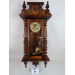 A 19th century continental glazed walnut cased Vienna-type wall clock,