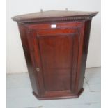 A 19th Century mahogany corner wall cupboard with a panelled door and fitted shelves est: £40-£60