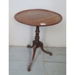 A pretty 19th Century mahogany tripod table with a dished top over a turned column and splayed legs