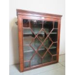 A 19th Century mahogany wall hanging display cabinet with a single astral glazed cupboard door est: