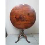 A Georgian mahogany tilt top table terminating on a tripod base est: £40-£60