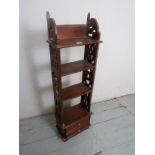 A 20th Century mahogany freestanding slim bookcase / display cabinet with fretwork panels and two