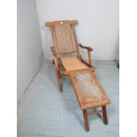 An early 20th Century folding steamer chair with cane seats est: £80-£120