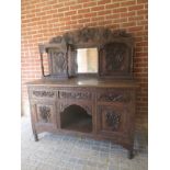 An Anglo-Burmese carved mirror-back sideboard with a central mirror to top over three carved