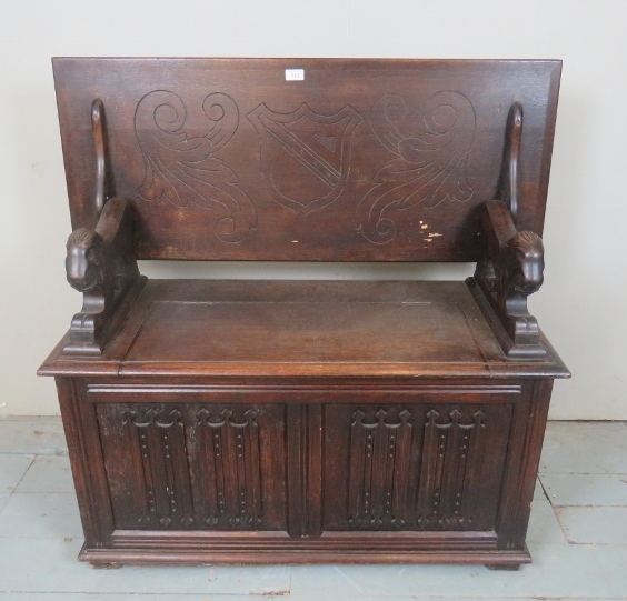 A 20th Century oak carved monks bench with a lift up seat est: £50-£100