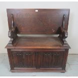 A 20th Century oak carved monks bench with a lift up seat est: £50-£100