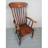 A 19th Century country armchair with an elm seat and in good condition est: £30-£50