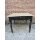 A rustic 19th Century painted pine square kitchen table with a single drawer to one end over turned