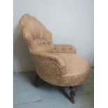 A Victorian mahogany framed shell back nursing chair upholstered in deep buttoned floral gold