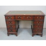 A late 20th Century mahogany pedestal writing desk with a green tooled leather top est: £50-£70