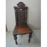 A 19th Century oak carved hall chair in clean condition est: £70-£90