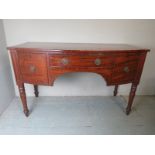 A 19th Century mahogany bow front sideboard with a central drawer flanked either side by cupboards