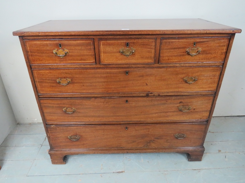A George III mahogany chest of three short over three long graduated drawers with boxwood stringing