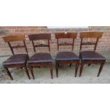 A set of four 19th Century mahogany dining chairs with deep brown leather upholstered seats over