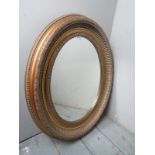 A small 20th Century gilt oval wall mirror est: £25-£45