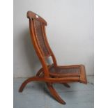 An Edwardian mahogany child's steamer chair with cane back and seat est: £30-£50