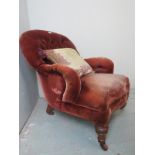 A Victorian mahogany framed button backed armchair upholstered in red velvet material (material