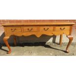 A 20th Century pine sideboard with four small drawers over cabriole legs est: £30-£50