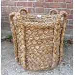 A small woven log basket with carry handles est: £25-£45