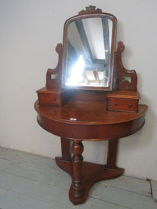 A Victorian mahogany demi lune dressing table with a swing mirror est: £40-£60