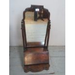 A Queen Anne design walnut table top cabinet with a shaped mirror over a fall front and with