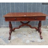 A Victorian mahogany and oak side table with two drawers over decorative carved upright supports