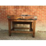 A 19th Century Butchers block with iron straps and a wooden base,