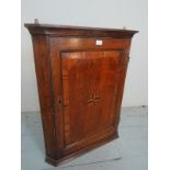 A Georgian oak corner wall cupboard with a decorative inlaid star to centre est: £80-£120