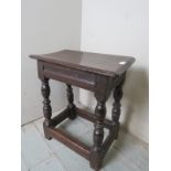 An 18th Century oak joint stool with a carved frieze over turned supports est: £150-£250