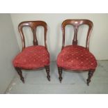 A pair of Victorian mahogany framed chairs with matching material to previous lot.