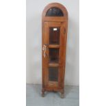 A 20th Century arched top freestanding cabinet with glass panels,