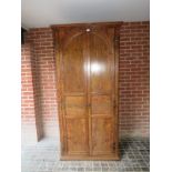 A 19th Century walnut double wardrobe with arched panelled doors est: £100-£150