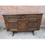 A 20th Century carved oak Old Charm sideboard with two drawers over cupboard doors est: £30-£50