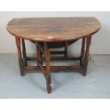 A Georgian oak gateleg drop leaf dining table in sound condition,