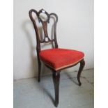 A pretty 19th Century carved and inlaid mahogany chair upholstered in red material (a/f) est:
